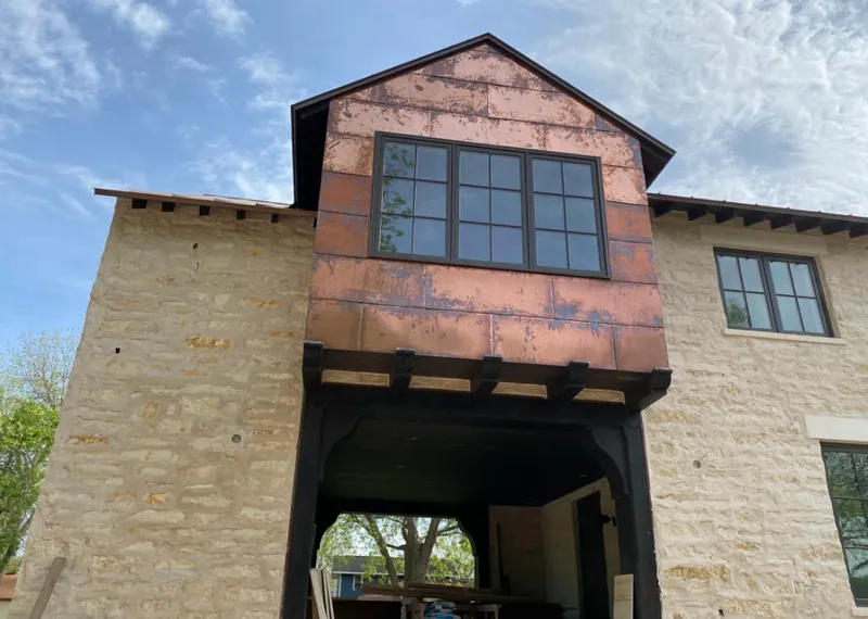Copper metal panel facade on a stone building for Skylight Installation in Uniontown